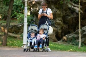 Mother with two baby in a stroller